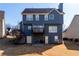 Two-story home with back patio, fenced yard, and a small deck off the second floor at 9989 Village South Dr, Douglasville, GA 30135
