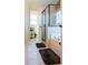 Bathroom featuring a tub and a glass shower with a view of the outside at 9989 Village South Dr, Douglasville, GA 30135
