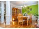 Traditional dining room boasts hardwood floors, a wooden table set, and an accent wall at 9989 Village South Dr, Douglasville, GA 30135