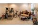 Well-lit exercise room featuring various workout machines, bikes, and a comfortable seating area at 9989 Village South Dr, Douglasville, GA 30135