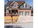 Charming two-story home featuring a stone and brick facade with a well-manicured front yard at 9989 Village South Dr, Douglasville, GA 30135