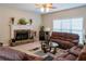 Cozy living room features a stone fireplace, plush sofas, and natural light at 9989 Village South Dr, Douglasville, GA 30135