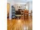 Open-concept living space featuring hardwood floors, a living room with fireplace, and dining area at 9989 Village South Dr, Douglasville, GA 30135
