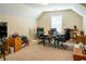 Home office with desk, chairs, and large bookcase for a comfortable workspace at 9989 Village South Dr, Douglasville, GA 30135