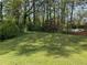 Expansive, tree-lined backyard offering a private and serene outdoor space at 1477 Springleaf Se Cir, Smyrna, GA 30080