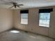 Simple bedroom with neutral walls, dual windows, ceiling fan, and an access door at 1477 Springleaf Se Cir, Smyrna, GA 30080