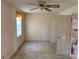 Spacious bedroom featuring a ceiling fan, window with blinds, and an en-suite bathroom at 1477 Springleaf Se Cir, Smyrna, GA 30080
