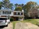 Street view of a brick townhome featuring a front yard and private parking at 1477 Springleaf Se Cir, Smyrna, GA 30080