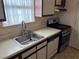 Cozy kitchen area showcasing a stainless steel stove, single bowl sink, and white appliances at 1477 Springleaf Se Cir, Smyrna, GA 30080
