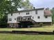 Home showcasing a lush backyard and a raised deck at 3798 Lee Ridge Sw Way, Lilburn, GA 30047
