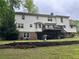 Backyard of the home featuring a raised deck and lush landscaping at 3798 Lee Ridge Sw Way, Lilburn, GA 30047