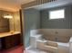 Bright bathroom features a soaking tub and a vanity with ample countertop space at 3798 Lee Ridge Sw Way, Lilburn, GA 30047
