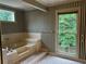 Relaxing bathroom features a soaking tub with a large window at 3798 Lee Ridge Sw Way, Lilburn, GA 30047