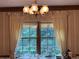 Dining room with a decorative chandelier, striped wallpaper and large windows with curtains at 3798 Lee Ridge Sw Way, Lilburn, GA 30047