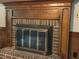 Brick fireplace with wood mantle, wooden accents and a metallic fireplace screen at 3798 Lee Ridge Sw Way, Lilburn, GA 30047