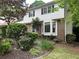 Charming home showcasing lush landscaping and mature trees at 3798 Lee Ridge Sw Way, Lilburn, GA 30047