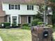 Well-maintained home featuring mature trees and manicured landscaping at 3798 Lee Ridge Sw Way, Lilburn, GA 30047