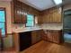 Traditional kitchen featuring wood cabinets, neutral countertops, and a window over the sink at 3798 Lee Ridge Sw Way, Lilburn, GA 30047