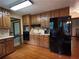 A kitchen featuring wood cabinets, black appliances, hardwood floors and great counter space at 3798 Lee Ridge Sw Way, Lilburn, GA 30047