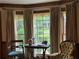 Living room featuring large bay windows with a view of the landscaped front yard at 3798 Lee Ridge Sw Way, Lilburn, GA 30047