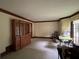 An empty living room featuring neutral carpet and a large cabinet against the wall at 3798 Lee Ridge Sw Way, Lilburn, GA 30047
