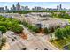 View of complex surrounded by streets and lush greenery with the cityscape in the background at 400 17Th Nw St # 2125, Atlanta, GA 30363