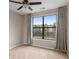 Bright bedroom featuring a ceiling fan, neutral walls, and a large window with decorative curtains at 400 17Th Nw St # 2125, Atlanta, GA 30363