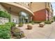 Modern building entrance features curved architecture, glass doors, lush landscaping, and concrete spheres at 400 17Th Nw St # 2125, Atlanta, GA 30363