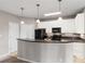 Kitchen features white cabinets, black appliances, stone countertops, and a breakfast bar at 400 17Th Nw St # 2125, Atlanta, GA 30363