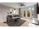 Comfortable living room featuring neutral walls, a ceiling fan, a TV and access to the balcony at 400 17Th Nw St # 2125, Atlanta, GA 30363