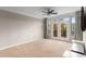 Living room with neutral walls, carpeted floors, ceiling fan, a TV and access to the balcony at 400 17Th Nw St # 2125, Atlanta, GA 30363
