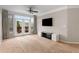 Spacious living room featuring neutral walls, a ceiling fan, a TV and access to the balcony at 400 17Th Nw St # 2125, Atlanta, GA 30363