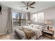 Bedroom featuring a ceiling fan, large window, side tables with lamps and neutral paint at 400 17Th Nw St # 2125, Atlanta, GA 30363