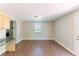 Dining room featuring wood floors, a window, and access to the kitchen and living room at 4170 N Quail N Dr, Douglasville, GA 30135