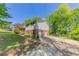 View of the home, garage and driveway, featuring a large lawn, mature trees, and partial fencing at 4170 N Quail N Dr, Douglasville, GA 30135