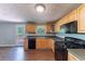 Kitchen with wood cabinets, laminate countertops, and black appliances at 4170 N Quail N Dr, Douglasville, GA 30135