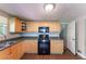 Bright kitchen with light wood cabinets, black appliances, and laminate countertops at 4170 N Quail N Dr, Douglasville, GA 30135