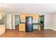 View of kitchen featuring wood cabinets, black refrigerator and wood floors with an open concept at 4170 N Quail N Dr, Douglasville, GA 30135