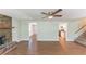 Open-concept living room showcasing wood floors, stairs to the second floor, and access to the kitchen at 4170 N Quail N Dr, Douglasville, GA 30135