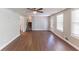 Bright living room featuring wood floors, access to the second floor and a partial view of the kitchen at 4170 N Quail N Dr, Douglasville, GA 30135
