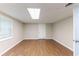 This room features wood-look flooring, a window, and a white door at 4170 N Quail N Dr, Douglasville, GA 30135