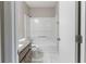 Bathroom featuring a granite-topped vanity and shower-tub combo at 5439 Farmview Close, Stone Mountain, GA 30088