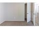 A bright bedroom with neutral carpeting and a closet, creating a cozy and functional space at 5439 Farmview Close, Stone Mountain, GA 30088