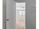 View from the walk-in closet to the bedroom, featuring a ceiling fan and double windows at 5439 Farmview Close, Stone Mountain, GA 30088