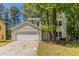 Charming two-story home with a two-car garage and mature trees in a suburban setting at 5439 Farmview Close, Stone Mountain, GA 30088