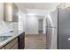 Modern kitchen with stainless steel appliances, granite countertops, and access to dining area at 5439 Farmview Close, Stone Mountain, GA 30088
