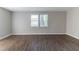 Spacious, neutral living room filled with natural light and featuring updated hardwood floors at 5439 Farmview Close, Stone Mountain, GA 30088