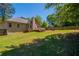 Lush backyard featuring a well-maintained lawn, wooden fence, a deck, and a fire pit area at 101 Valleydale Dr, Stockbridge, GA 30281