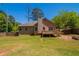Lush backyard featuring a well-maintained lawn, wooden fence, a deck, and a fire pit area at 101 Valleydale Dr, Stockbridge, GA 30281