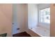 Bathroom featuring a soaking tub with a window for natural light at 101 Valleydale Dr, Stockbridge, GA 30281
